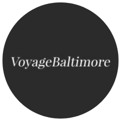 Black circular Voyage Baltimore logo with white text.
